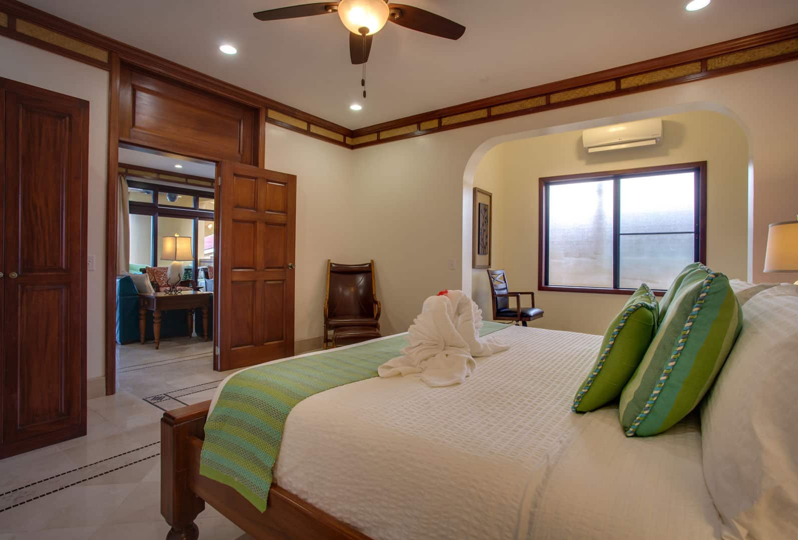 Rear view of the king sized bed inside the master bedroom of Villa Margarita Beachfront Deluxe Rooms at The Resort at Almond Beach