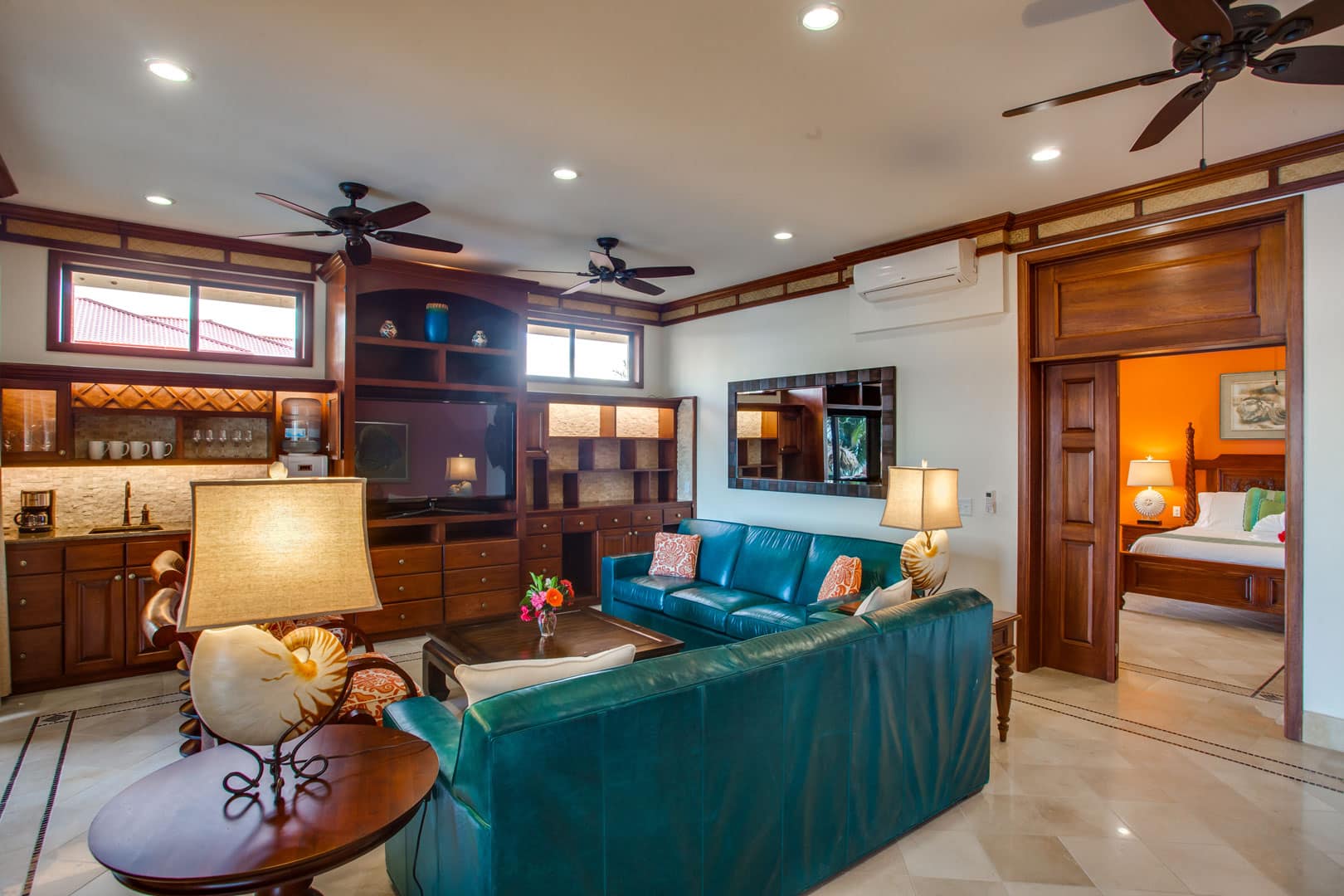 Living room area with couches and television inside of the Villa Margarita Beachfront Deluxe Rooms at The Resort at Almond Beach