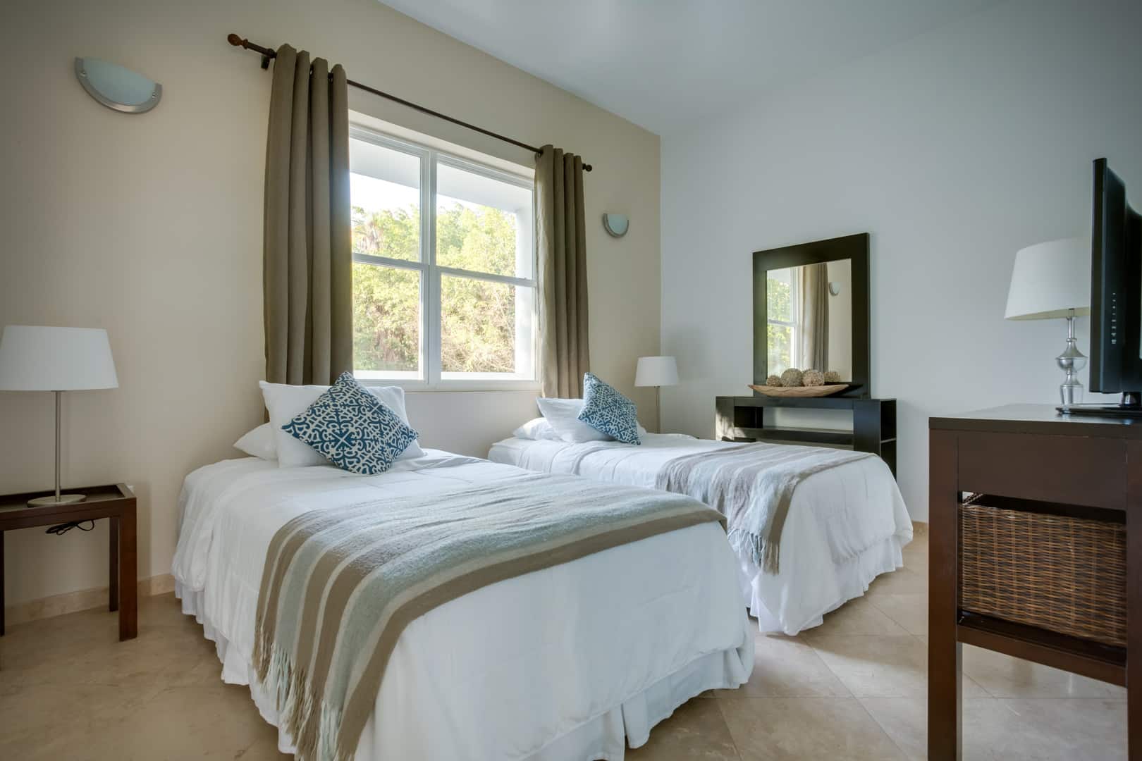 Front facing view of the guest bedroom with two queen sized beds inside the 2 Bedroom Penthouse Lagoon Bayview at Umaya Resort & Adventure