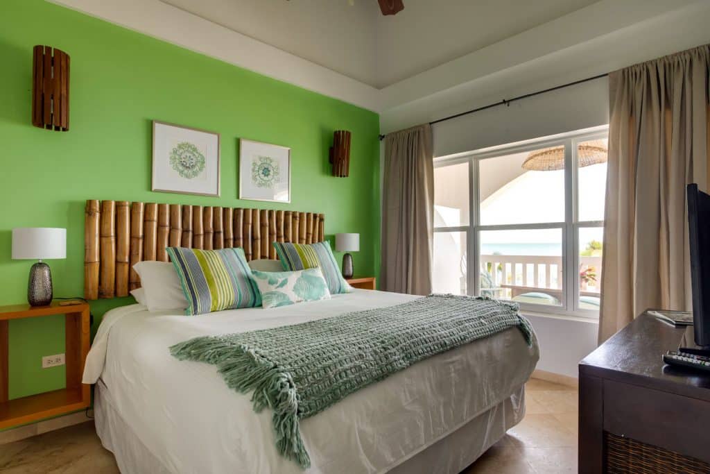 The master bedroom with a king sized bed with pillows and linen inside of the 1 Bedroom Beachfront at Umaya Resort & Adventure