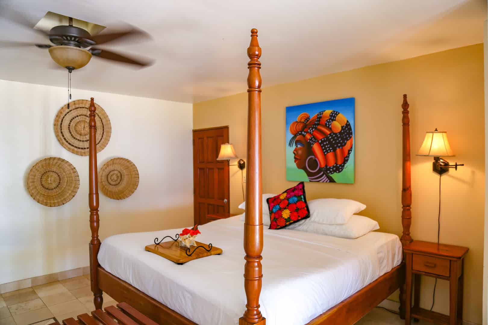 Corner view of the master bedroom with linen and pillows inside the Colonial Beachfront Rooms at The Colonial Inn