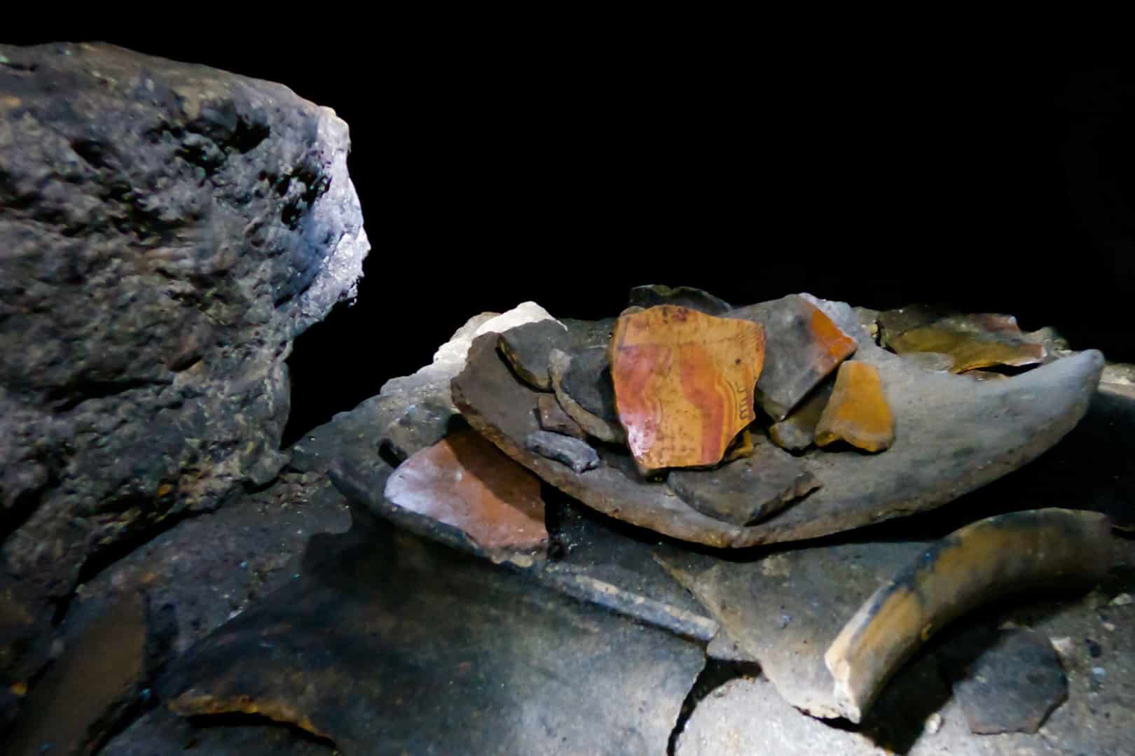 Broken pieces of pottery inside the ceremonial cave the Rainforest Lodge at Sleeping Giant