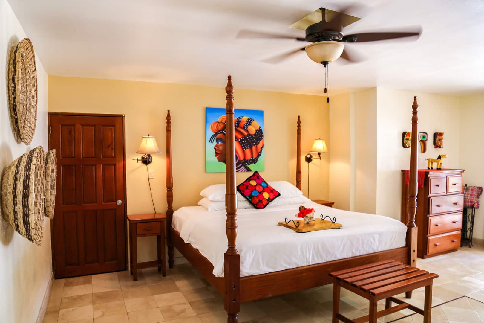 Master bedroom with a king sized bed inside the Colonial Beachfront Rooms at The Colonial Inn