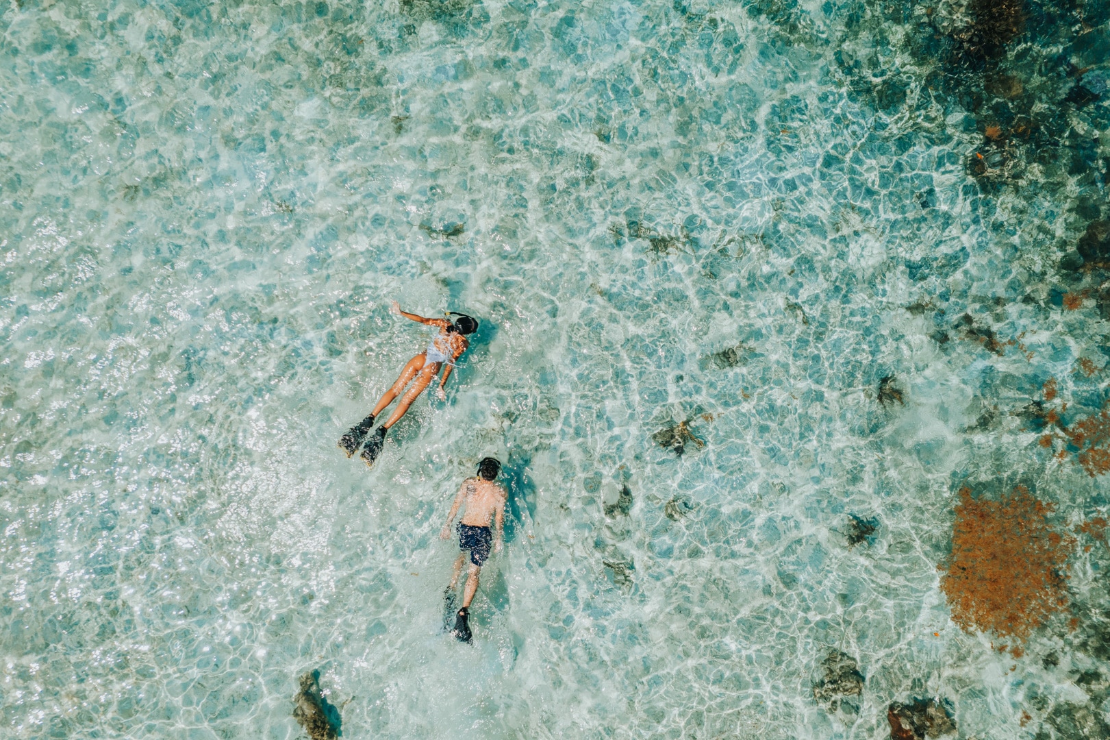 Two guests snorkeling in open waters by the Belize Barrier Reef at the Barrier Reef Snorkel at Umaya Resort & Adventures