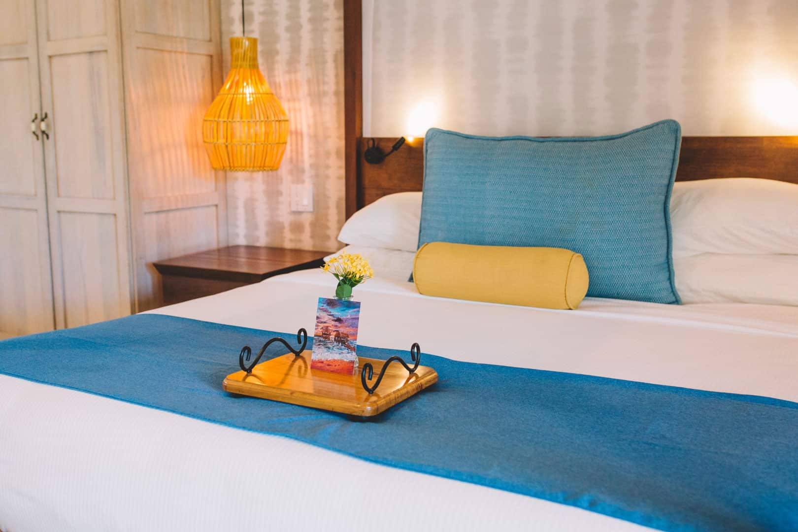 The master bedroom with a queen sized bed that has pillows and linen inside of the Deluxe Suite Upper Level with Plunge Pool at The Lodge at Jaguar Reef Resort