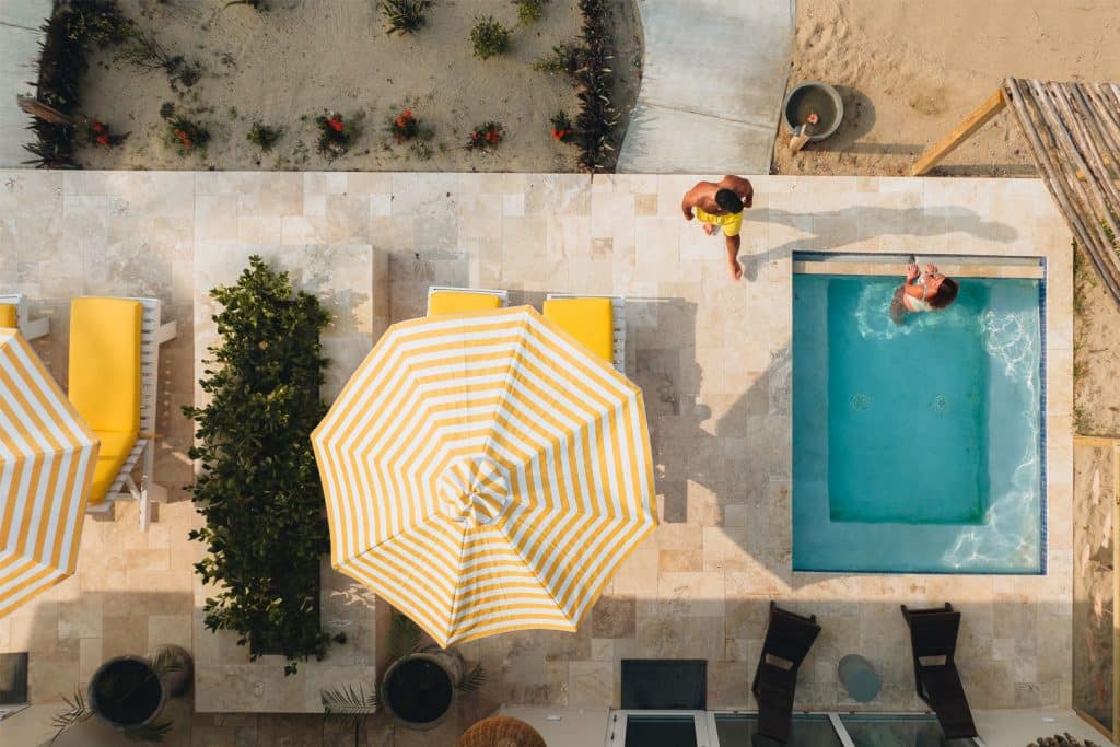 two guests relaxing a plunge pool at The Lodge at Jaguar Reef