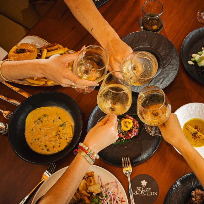 Group of guests enjoying food and drinks at Humo Restaurant, The Banks Resort, Belize