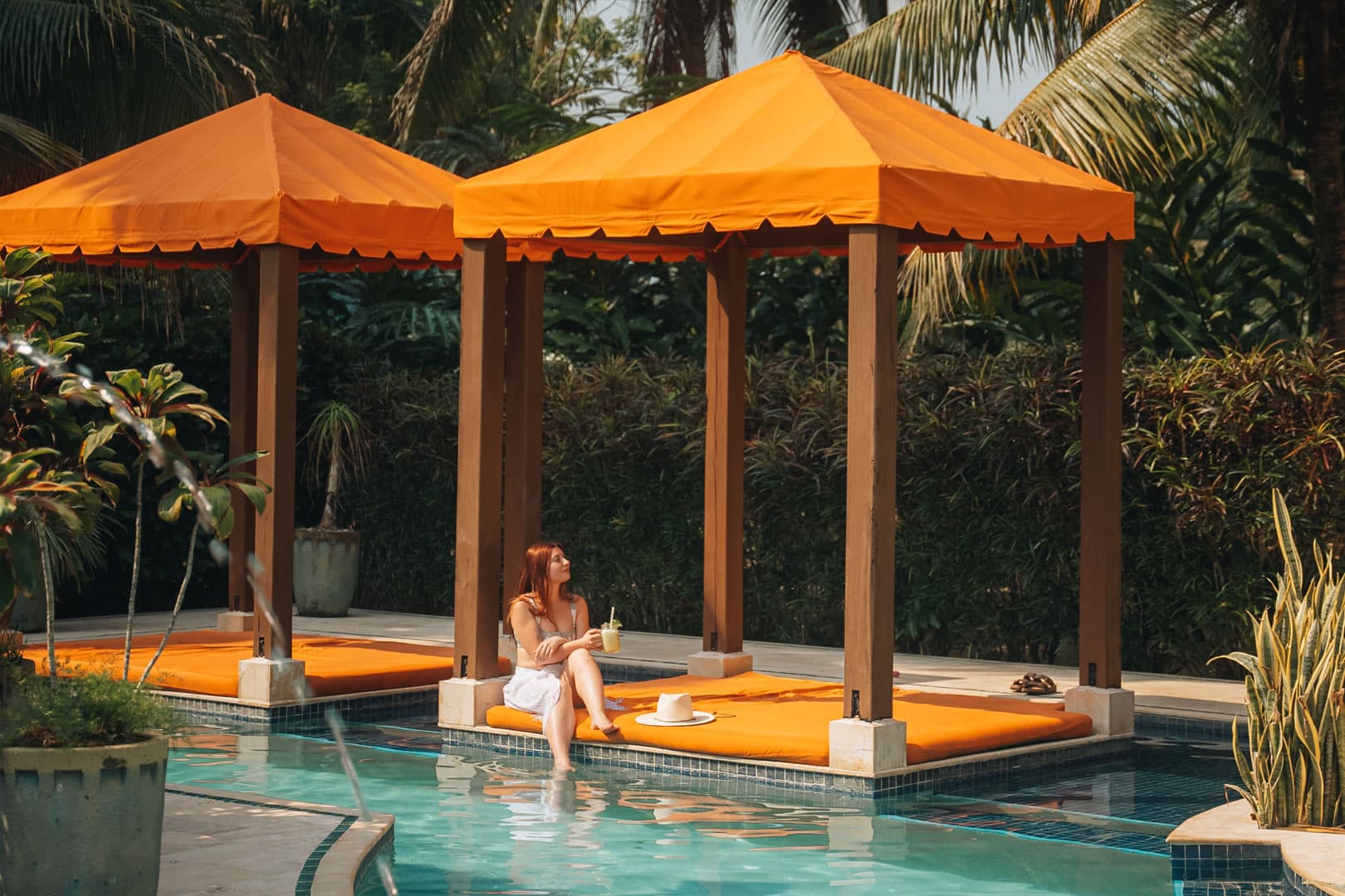 Guest relaxing by the jungle poolside at Sleeping Giant Rainforest Lodge, Sibun River Valley, Cayo District, Belize