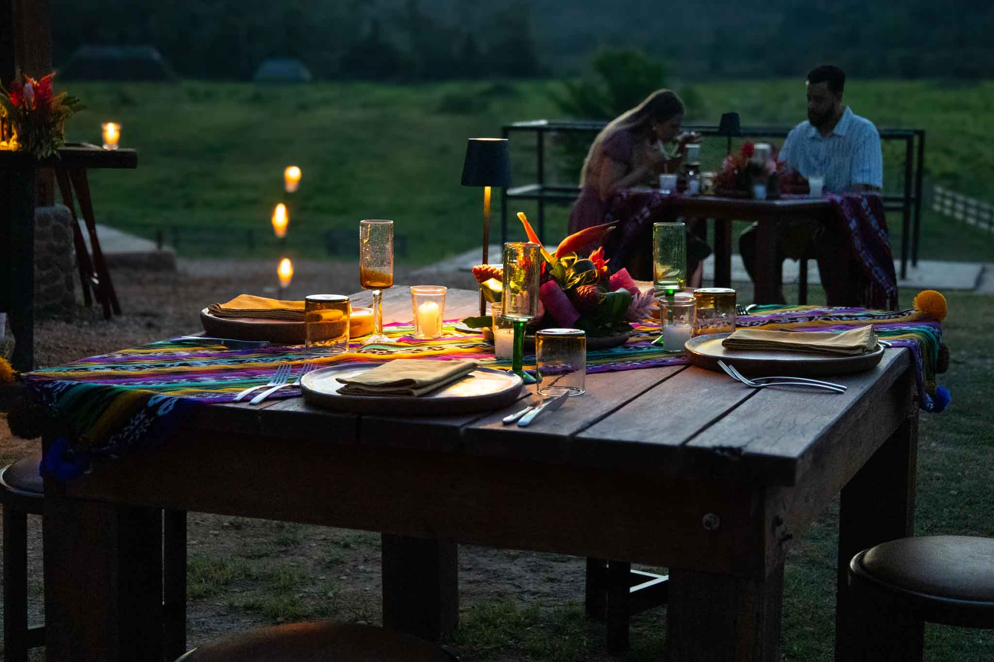Elegant dinner setup at The Stables during Full Moon Lights Out at The Rainforest Lodge at Sleeping Giant