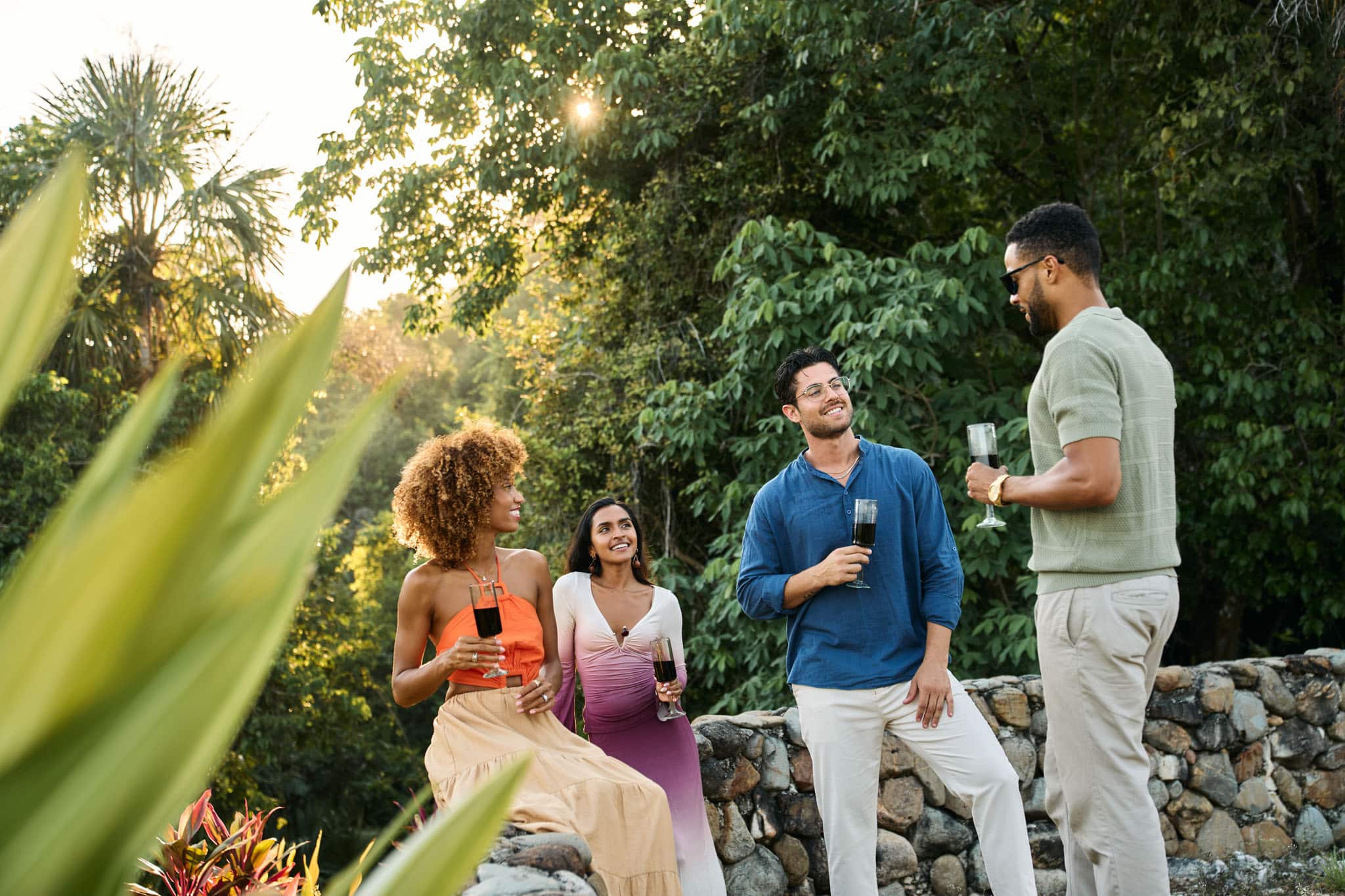 A group of friends enjoying wine on the cliff at Sleeping Giant in the Sibun River Valley, Cayo, Belize.