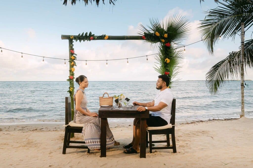 Elegant private beachside dinner setup at Umaya Resort on the Placencia Peninsula, Southern Belize