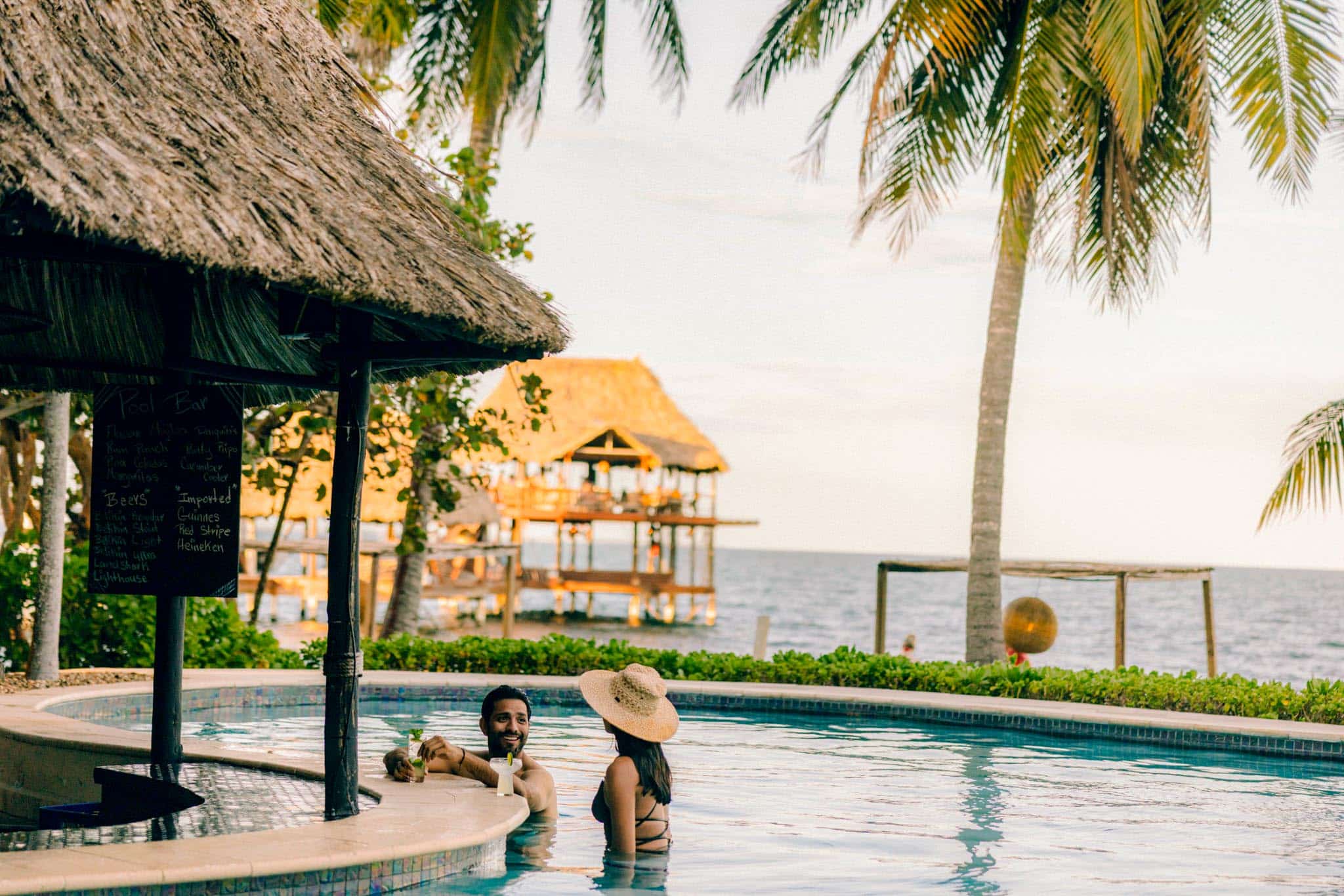 Two guests relaxing at Charlie's pool bar at The Resort at Almond Beach.